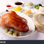 stock-photo-whole-peking-duck-served-with-the-sides-sauces-and-wraps-1567287802